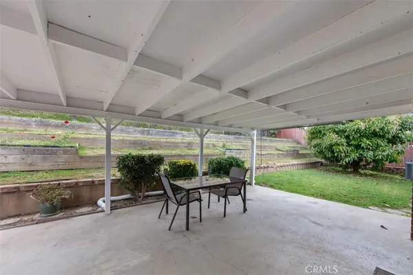 a patio with yard table and chairs