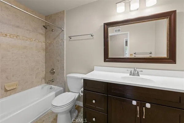 a bathroom with a sink vanity mirror and toilet