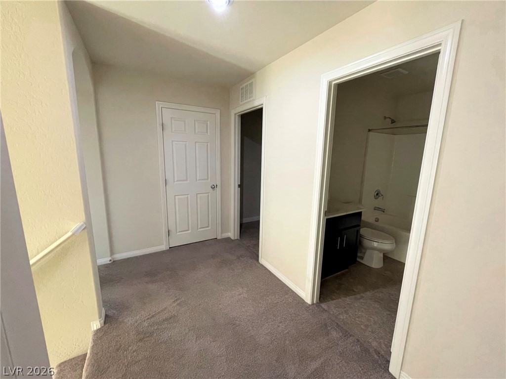 7063 Claythorn Road Las Vegas, NV 89148 - Photo 11 of 30 A versatile upper-level landing with access to additional rooms, including a well-appointed full bathroom.