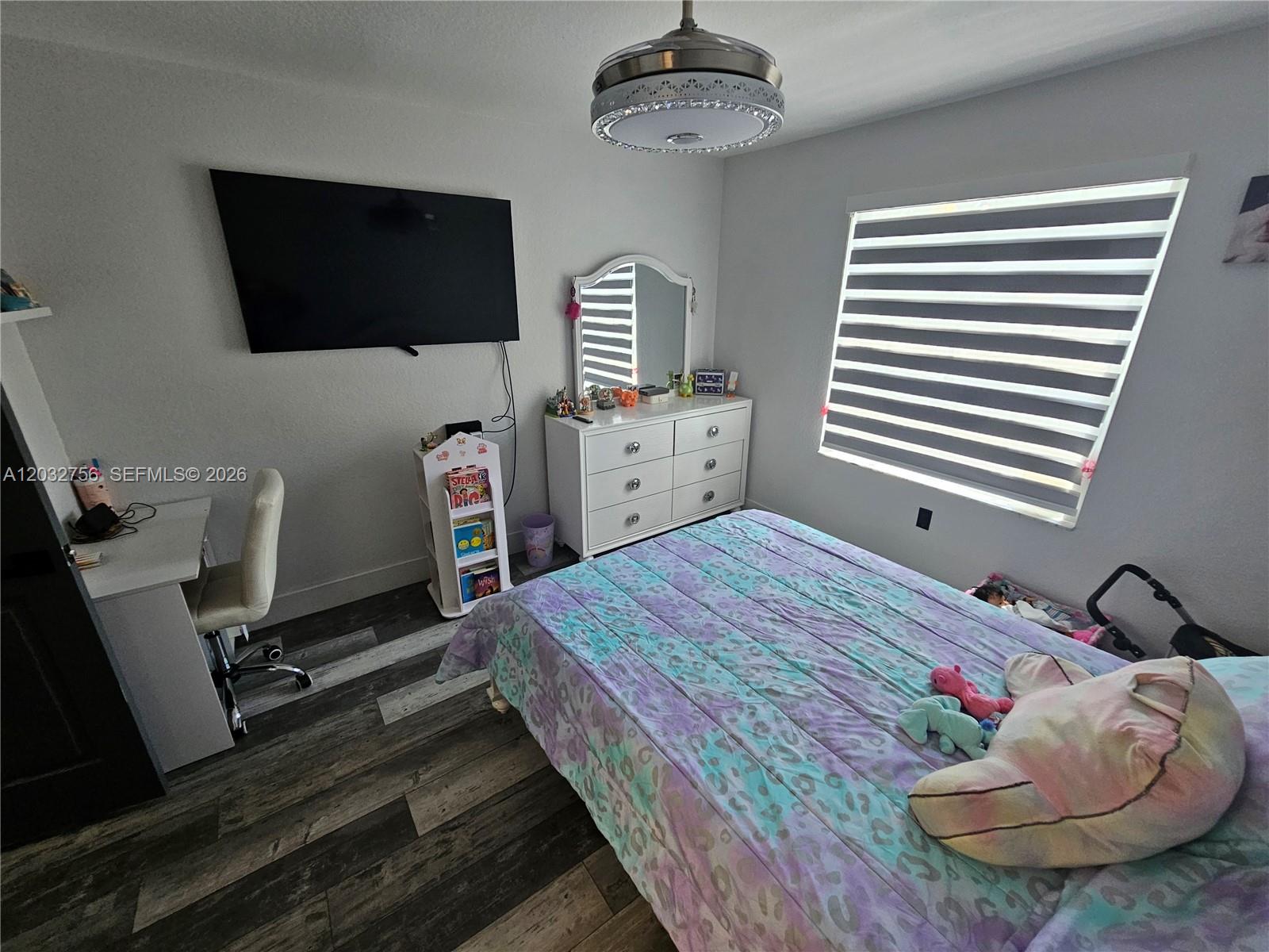 4331 Southwest 124th Way Miramar, FL 33027 - Photo 17 of 40 a bedroom with a bed and flat screen tv