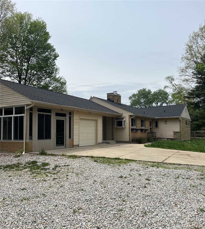 This charming residence features an attached garage and a lovely screened porch.