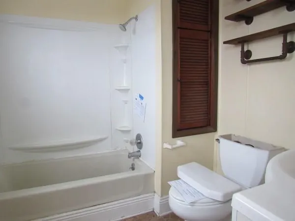 a bathroom with a bathtub and a shower