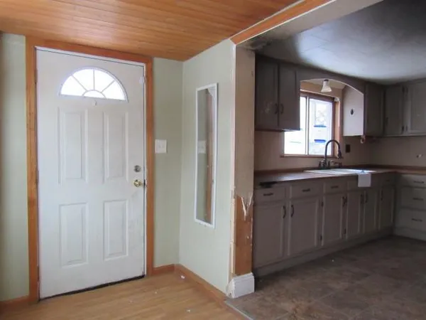 a spacious bathroom with mirror and window