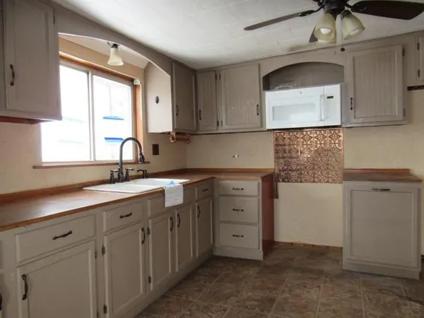 a kitchen with cabinets a sink and appliances