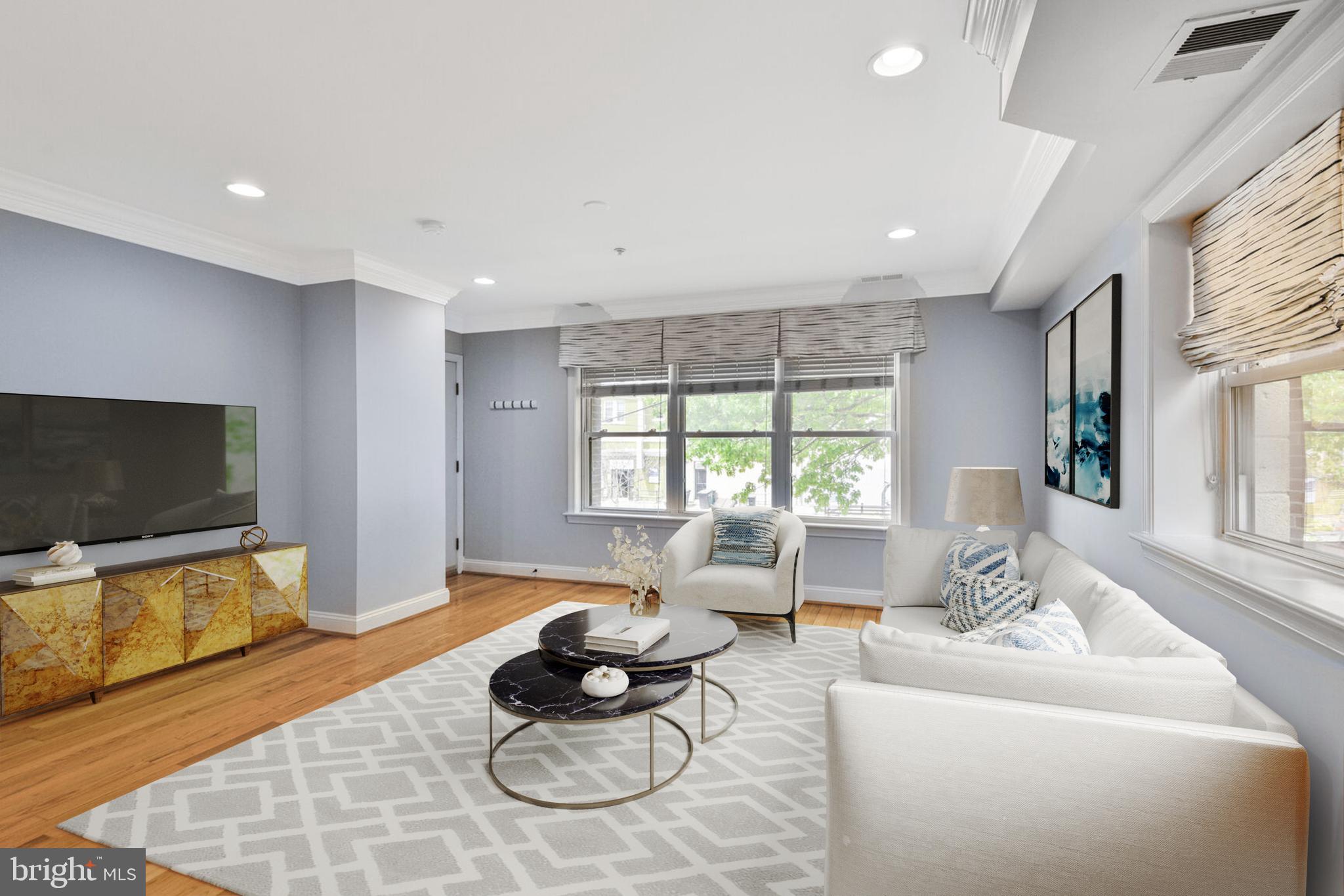 5511 Colorado Avenue Northwest, Unit 201 Washington, DC 20011 - Photo 1 of 15 a living room with furniture a flat screen tv and a large window