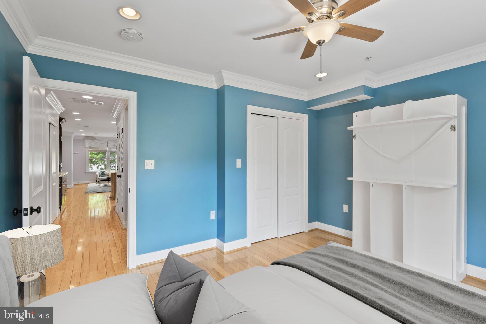 5511 Colorado Avenue Northwest, Unit 201 Washington, DC 20011 - Photo 11 of 15 a bedroom with a bed and a chandelier