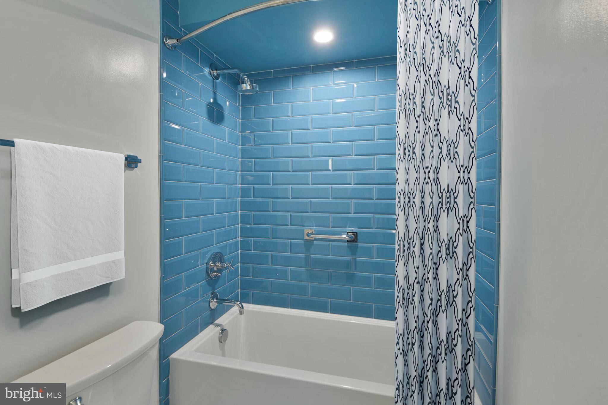 5511 Colorado Avenue Northwest, Unit 201 Washington, DC 20011 - Photo 12 of 15 a bathroom with a bathtub and shower