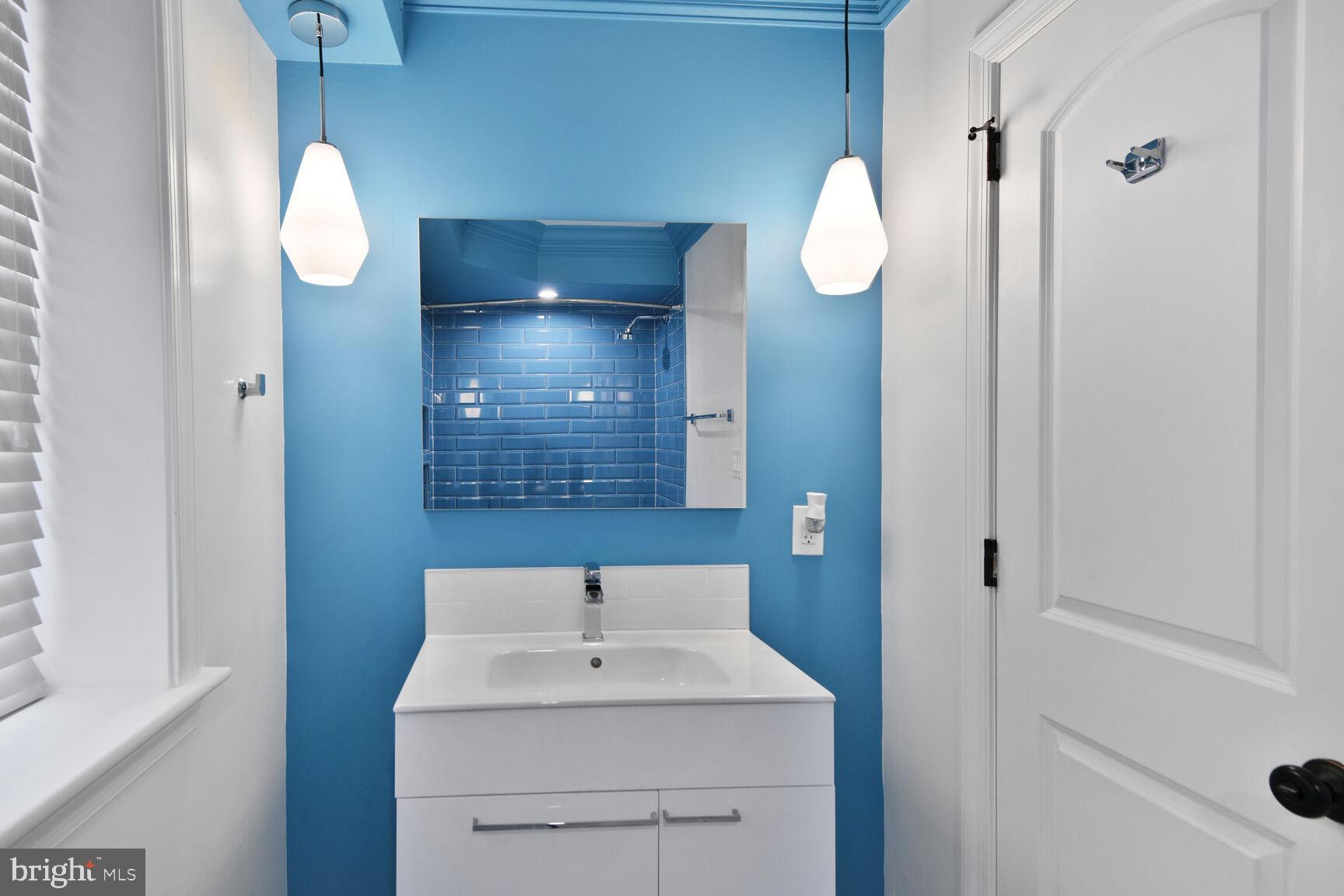 5511 Colorado Avenue Northwest, Unit 201 Washington, DC 20011 - Photo 13 of 15 a bathroom with a sink vanity and mirror