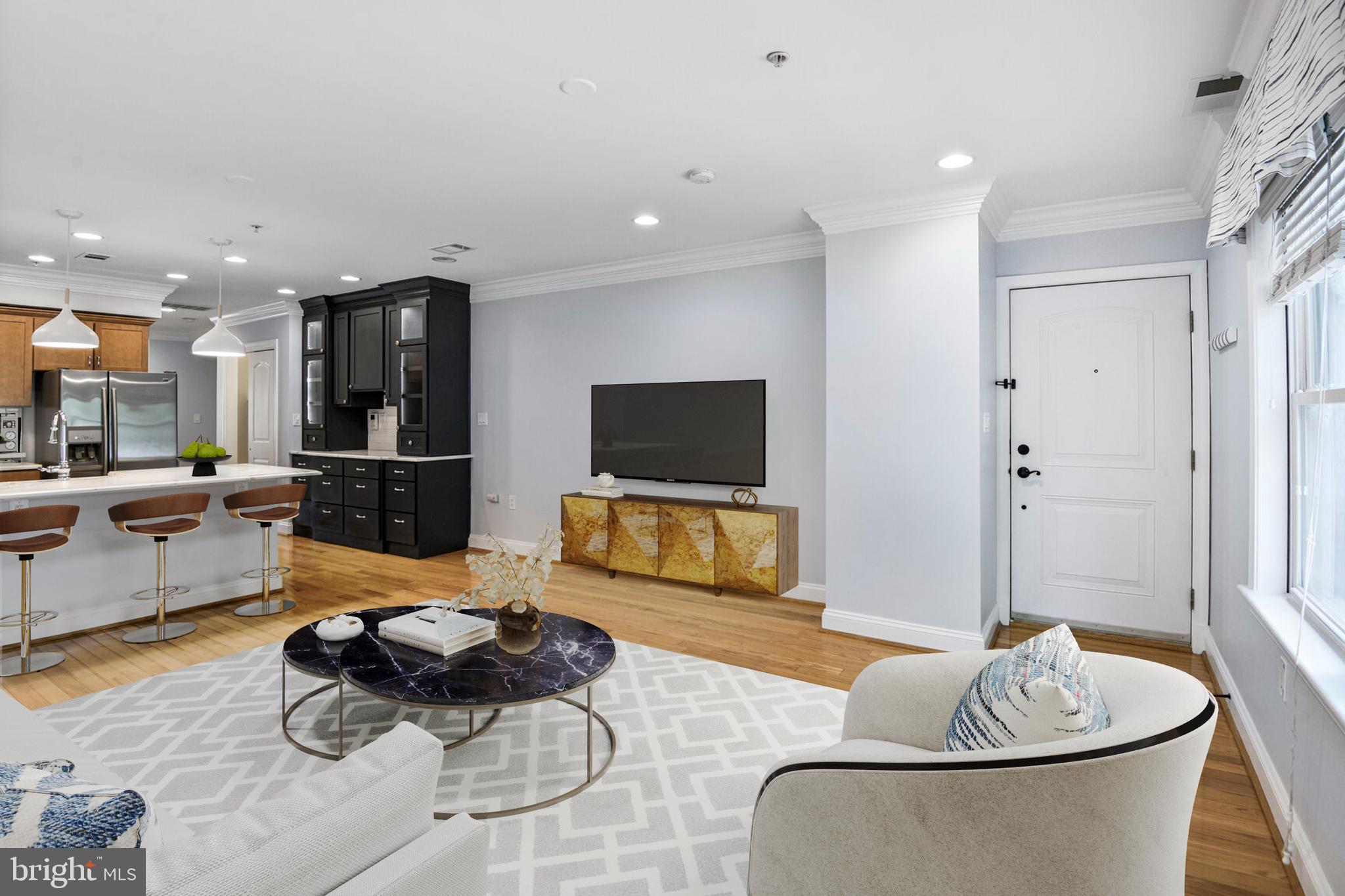 5511 Colorado Avenue Northwest, Unit 201 Washington, DC 20011 - Photo 2 of 15 a living room with furniture and a flat screen tv