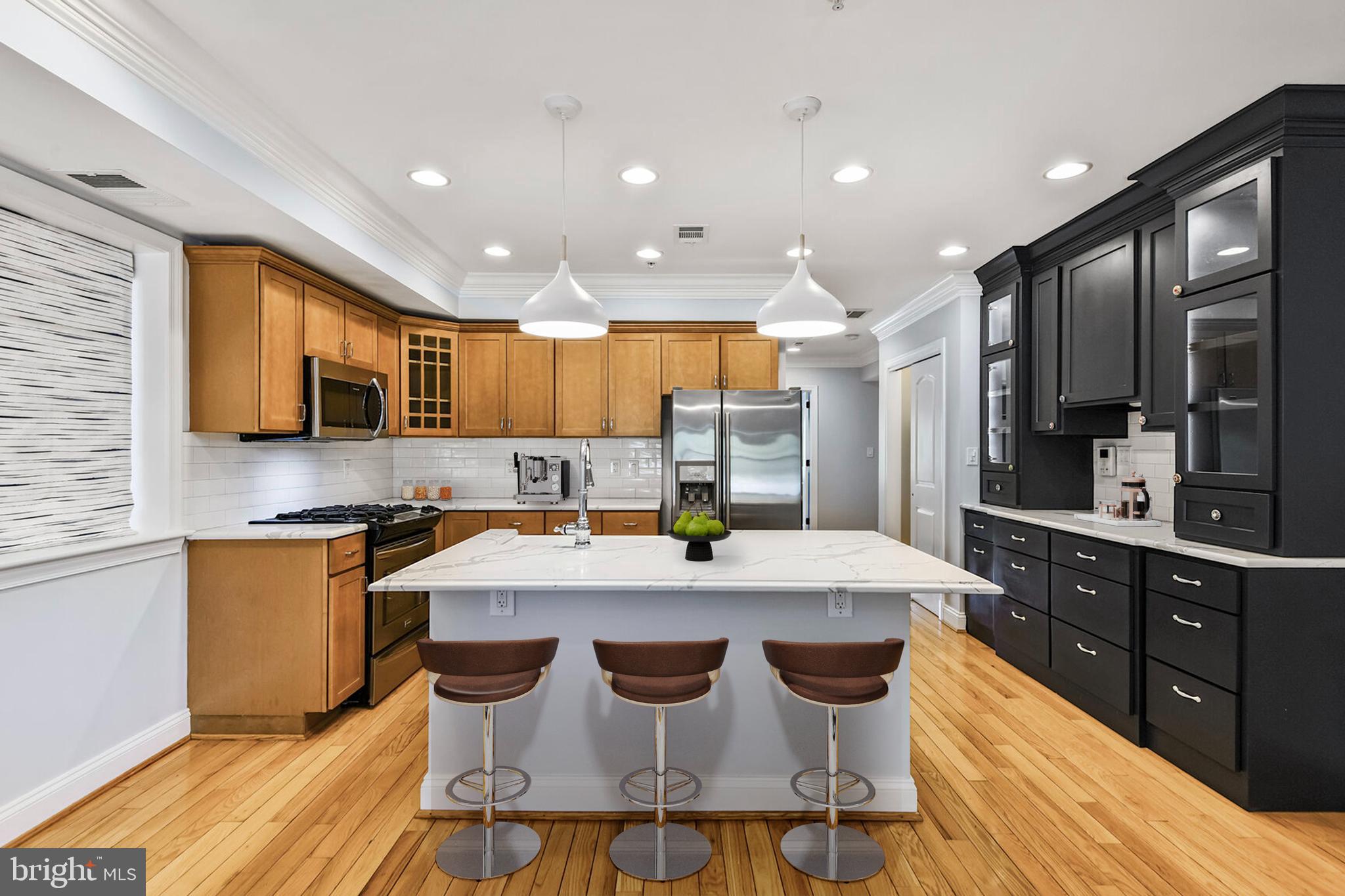 5511 Colorado Avenue Northwest, Unit 201 Washington, DC 20011 - Photo 3 of 15 a kitchen with stainless steel appliances kitchen island granite countertop a stove a sink and a refrigerator