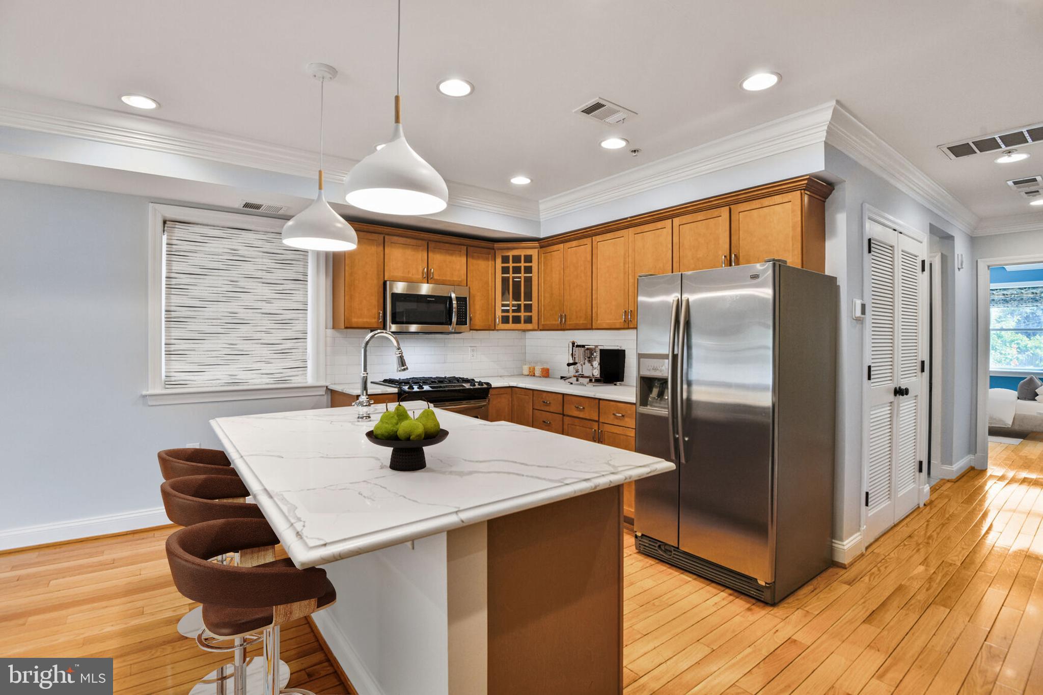 5511 Colorado Avenue Northwest, Unit 201 Washington, DC 20011 - Photo 4 of 15 a kitchen with stainless steel appliances granite countertop a sink a refrigerator and a refrigerator