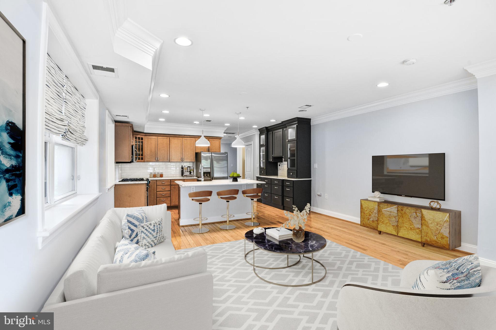 5511 Colorado Avenue Northwest, Unit 201 Washington, DC 20011 - Photo 5 of 15 a living room with furniture kitchen view and a flat screen tv