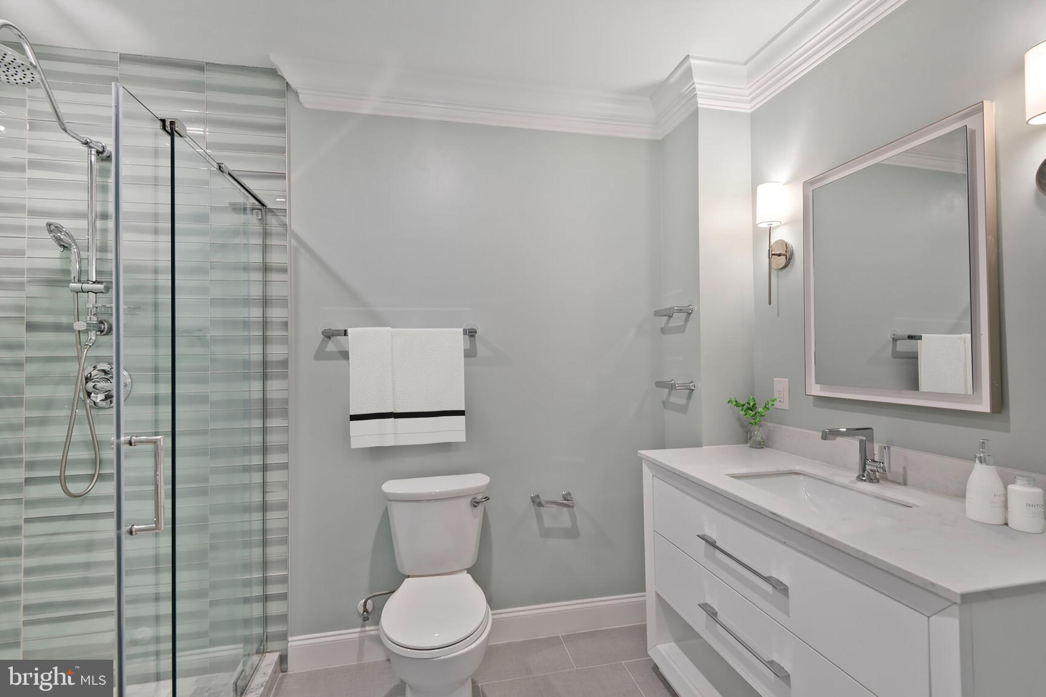 5511 Colorado Avenue Northwest, Unit 201 Washington, DC 20011 - Photo 9 of 15 a bathroom with a granite countertop sink toilet and shower