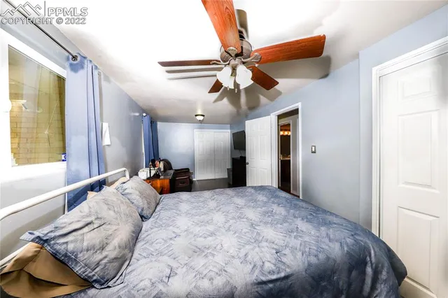 a bed room with a bed and a large mirror