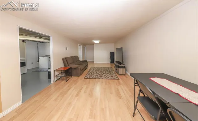 a living room with a couch and a wooden floor