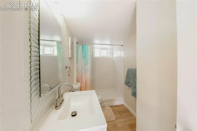 a bathroom with a sink a mirror and a shower