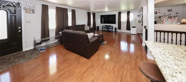 a living room with furniture and a flat screen tv