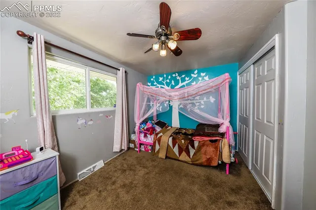a bedroom with furniture and a window