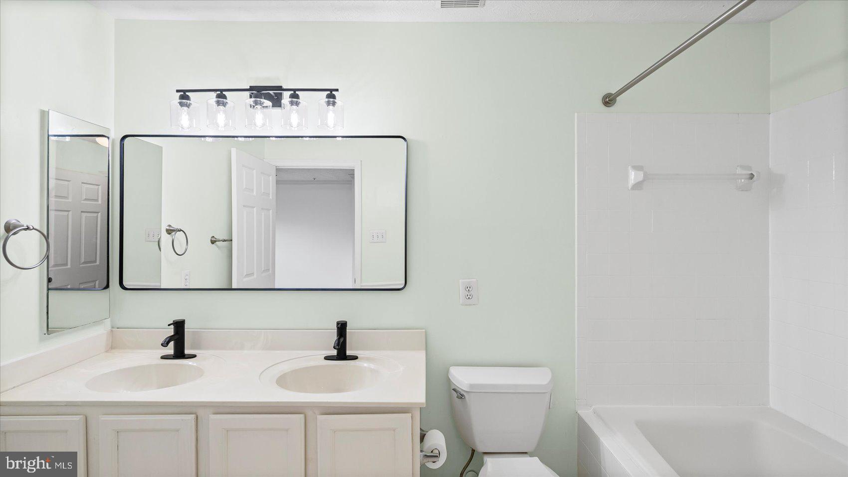 5108 Windermere Circle Baltimore, MD 21237 - Photo 19 of 38 a bathroom with a sink a toilet and mirror