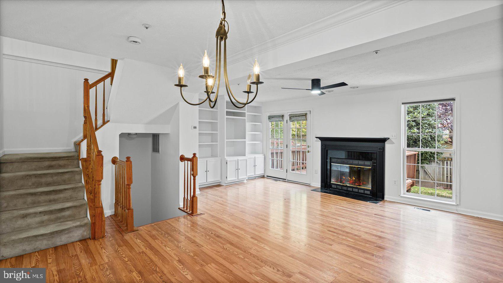 5108 Windermere Circle Baltimore, MD 21237 - Photo 8 of 38 a view of empty room with wooden floor fireplace and windows
