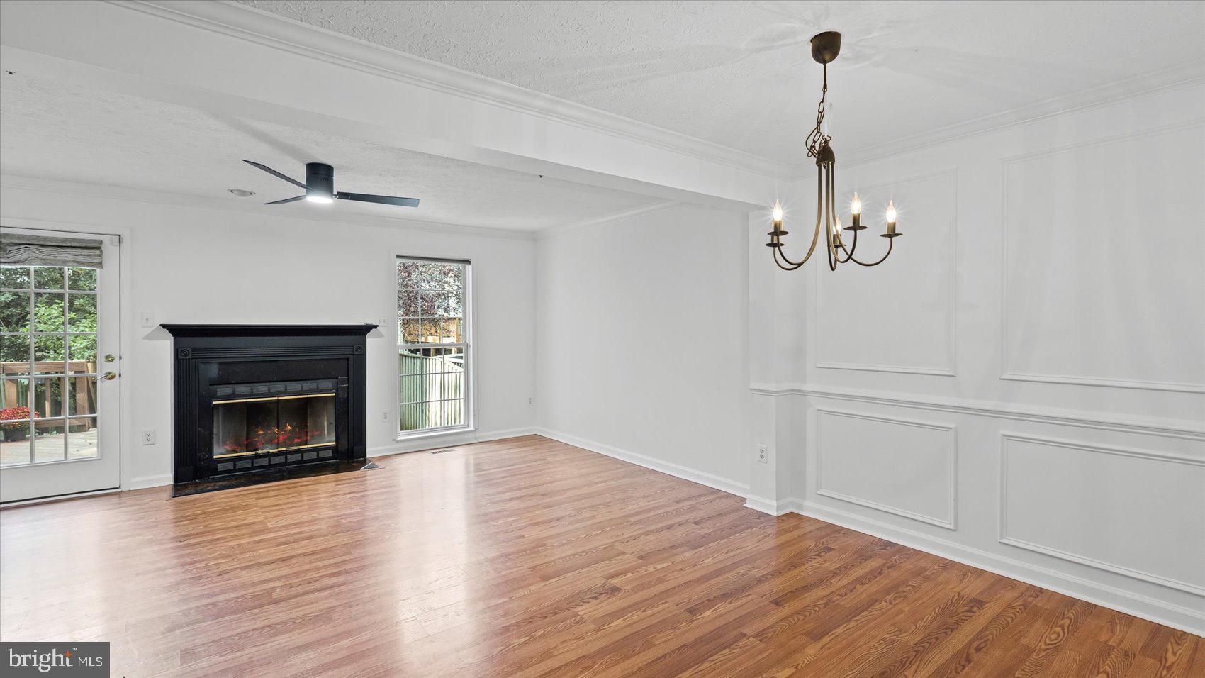 5108 Windermere Circle Baltimore, MD 21237 - Photo 10 of 38 a view of empty room with a fireplace wooden floor and fan