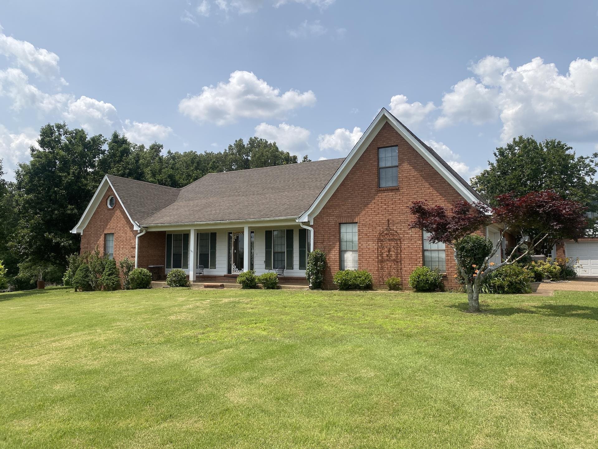240 Sawmill Road Brighton, TN 38011 - Photo 1 of 25 View of front of property featuring brick siding, covered porch, a front yard, and a shingled roof