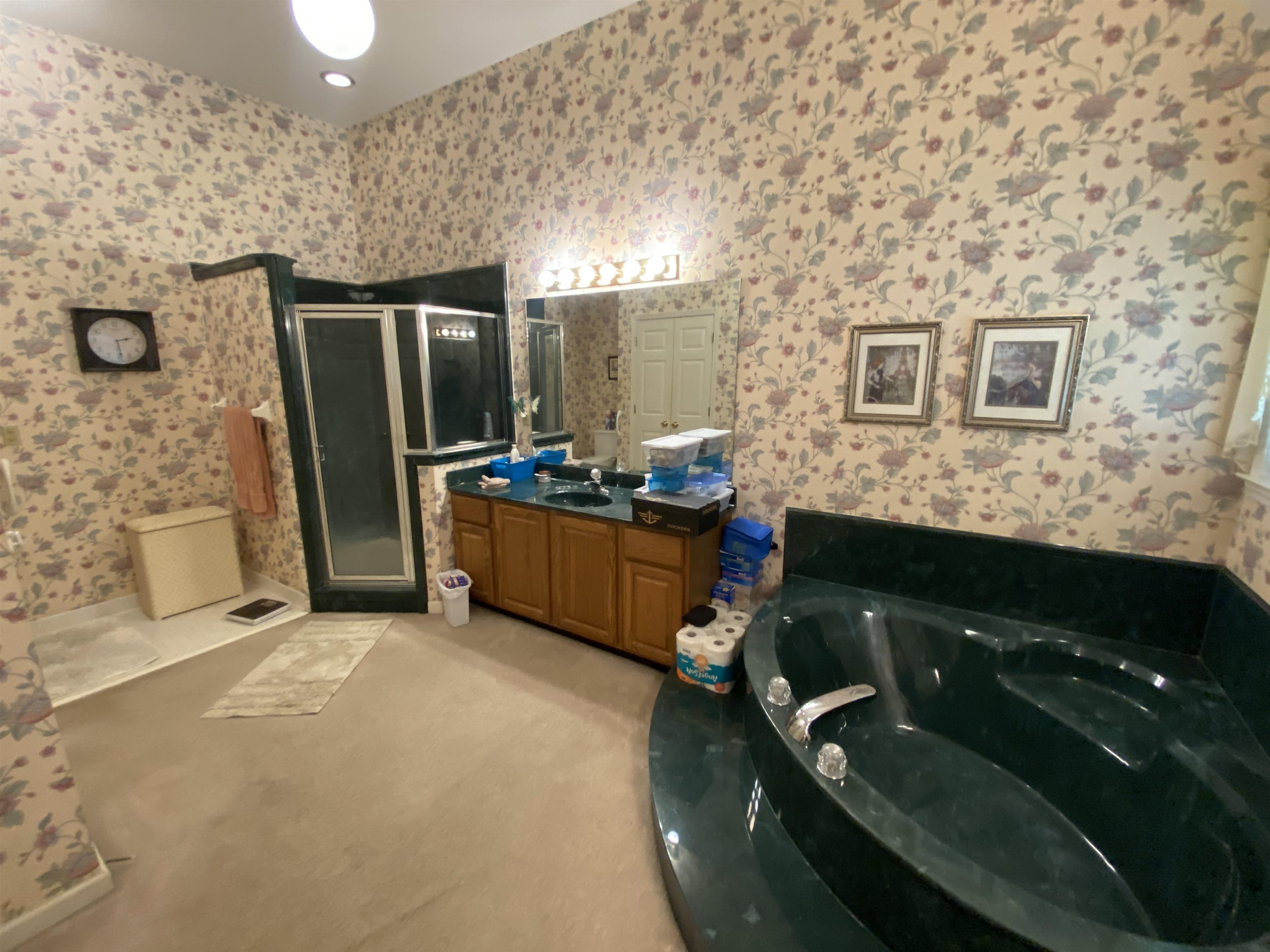 240 Sawmill Road Brighton, TN 38011 - Photo 17 of 25 Full bathroom with wallpapered walls, a shower stall, vanity, and a whirlpool tub