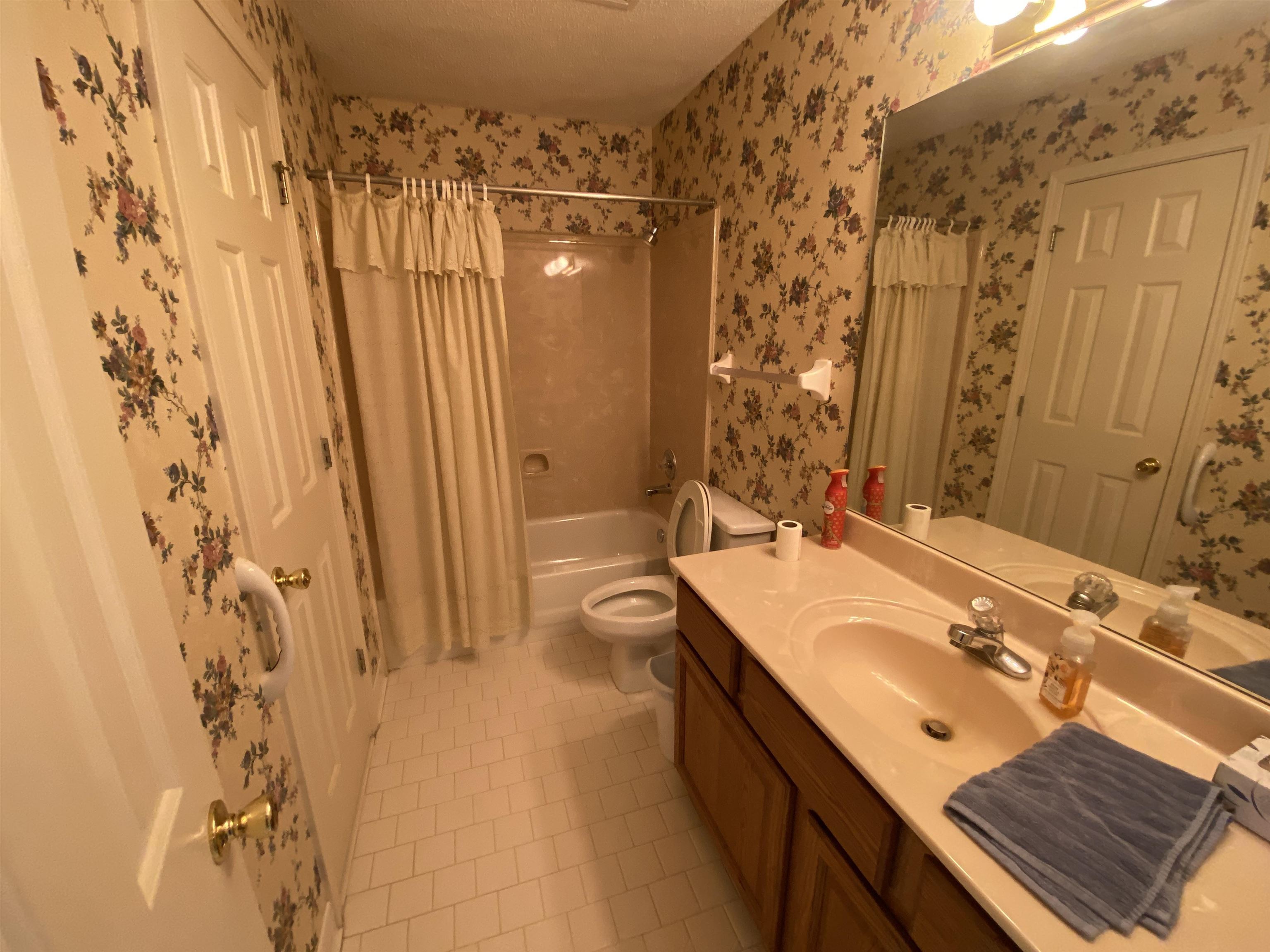 240 Sawmill Road Brighton, TN 38011 - Photo 19 of 25 Full bathroom featuring tile patterned floors, shower / bath combo, vanity, toilet, and wallpapered walls