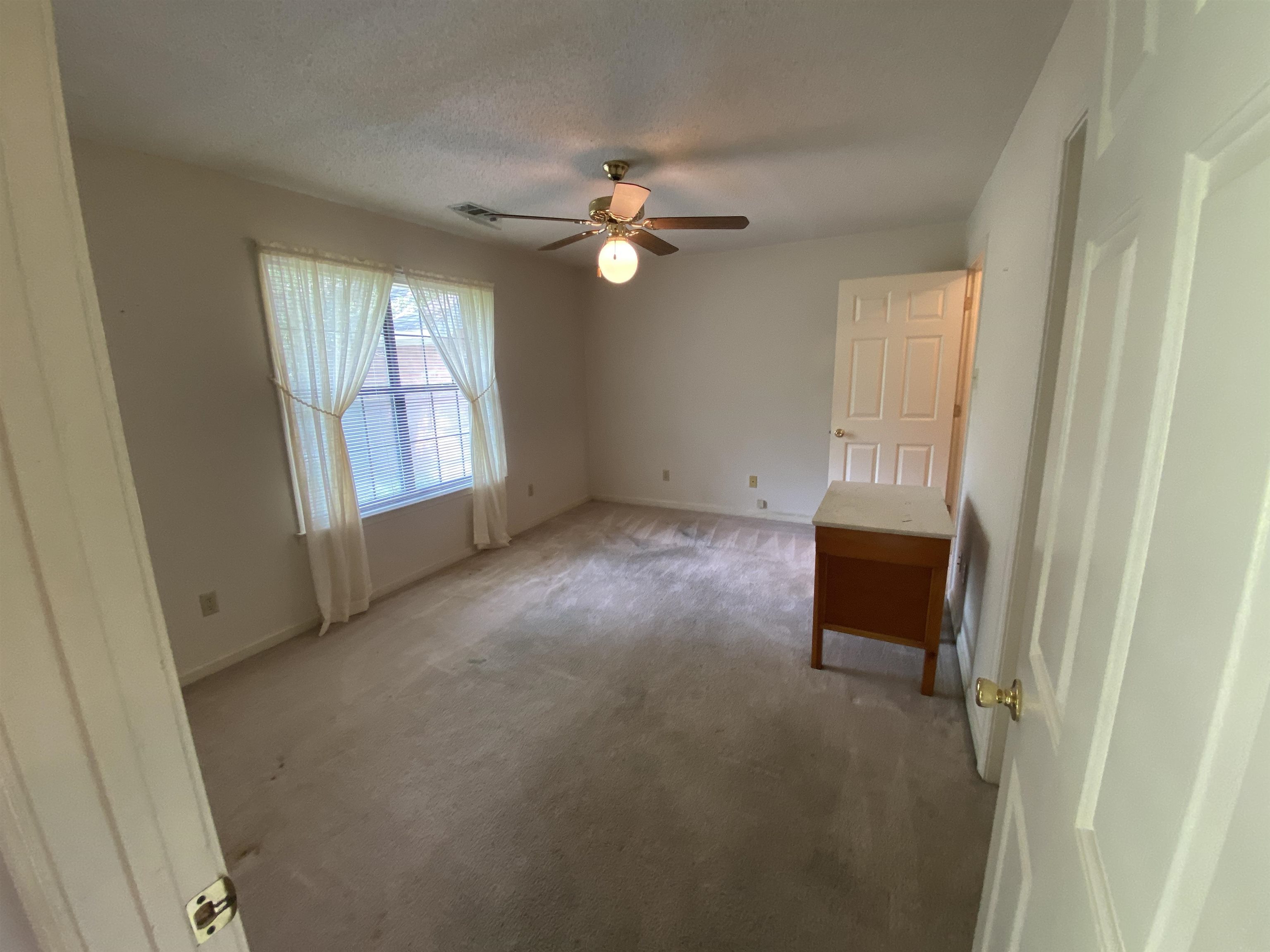 240 Sawmill Road Brighton, TN 38011 - Photo 21 of 25 Unfurnished bedroom featuring light colored carpet, baseboards, ceiling fan, and a textured ceiling