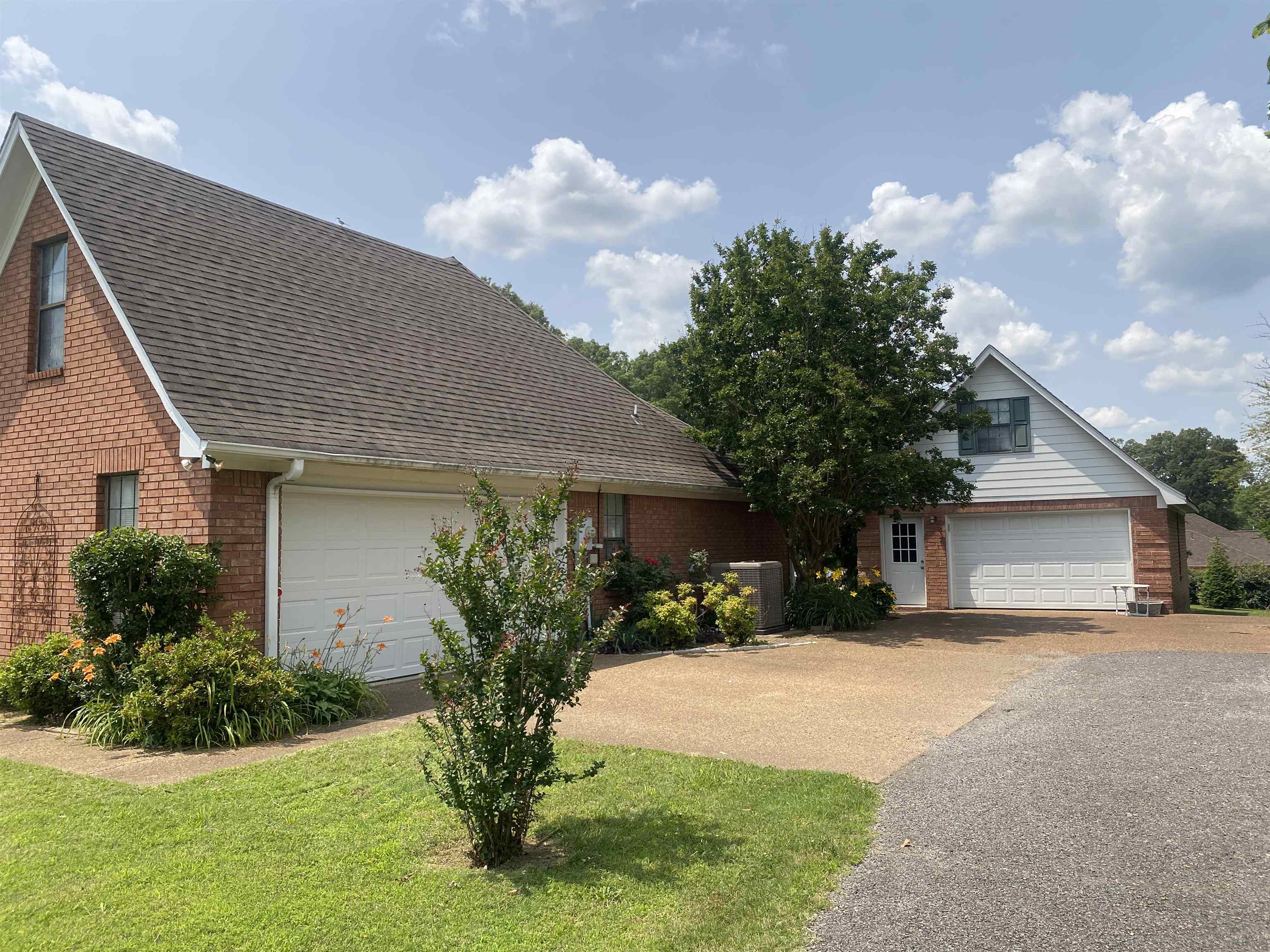 240 Sawmill Road Brighton, TN 38011 - Photo 4 of 25 View of front of home with brick siding, driveway, and roof with shingles