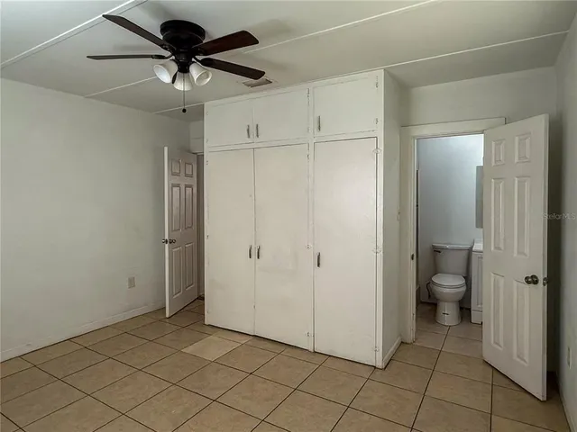 a view of a hallway with a bathroom