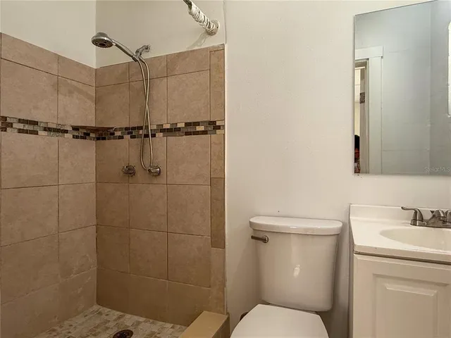 a bathroom with a toilet sink and shower