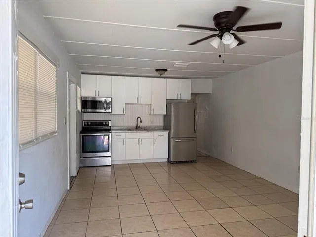 a kitchen with stainless steel appliances a refrigerator sink and microwave