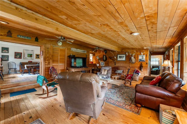 a view of a dining room with furniture a chandelier and wooden floor