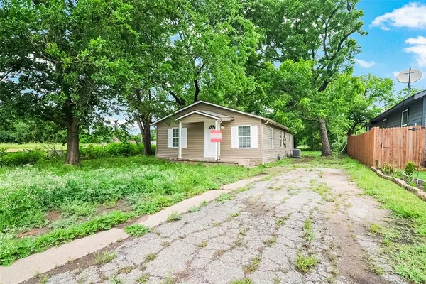 a view of backyard of house with green space