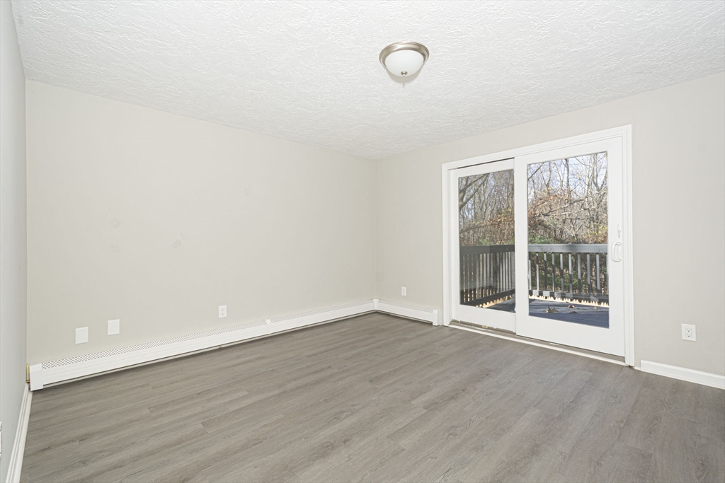 55 Dodge Road Sutton, MA 01590 - Photo 16 of 35 an empty room with wooden floor and windows
