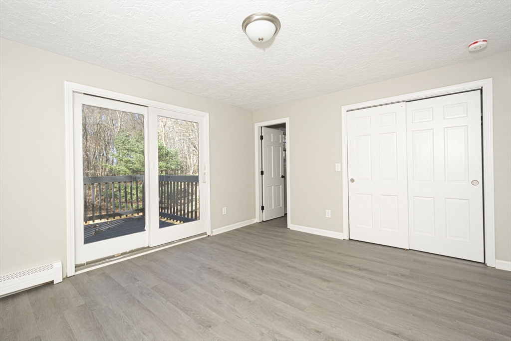 55 Dodge Road Sutton, MA 01590 - Photo 17 of 35 an empty room with wooden floor and windows