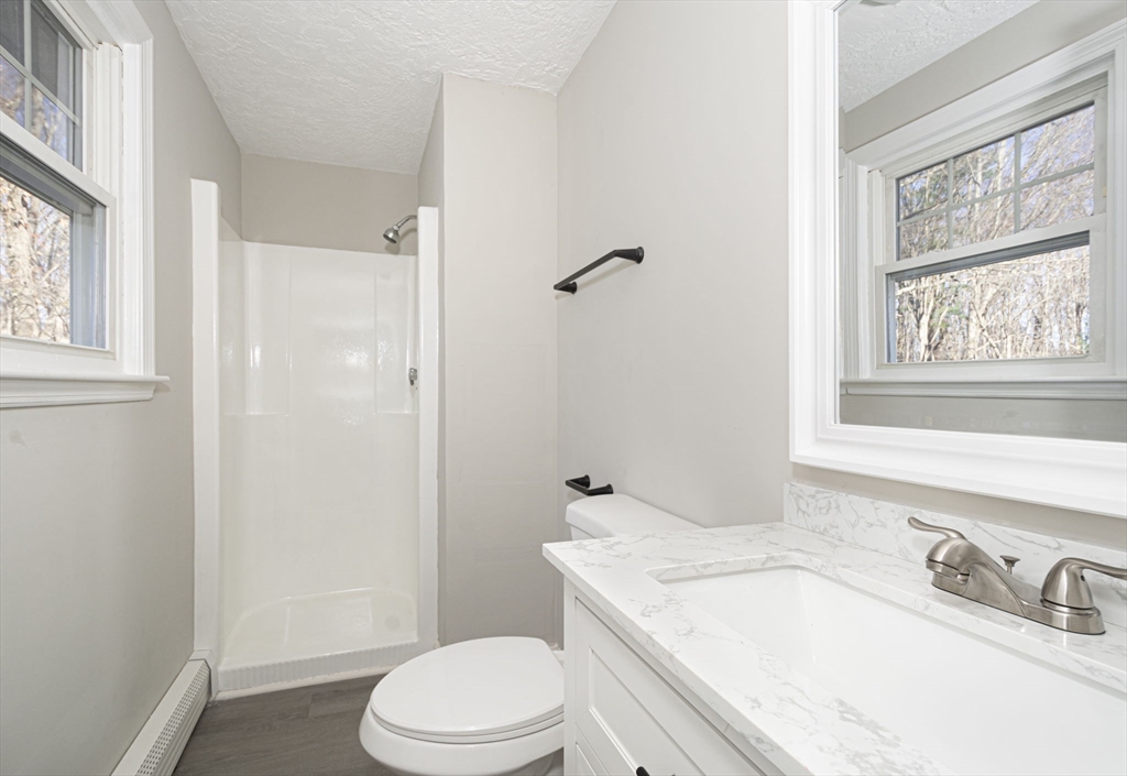 55 Dodge Road Sutton, MA 01590 - Photo 18 of 35 a bathroom with a sink a toilet and shower