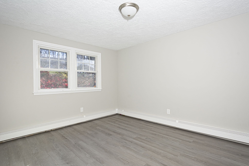 55 Dodge Road Sutton, MA 01590 - Photo 19 of 35 an empty room with wooden floor and windows