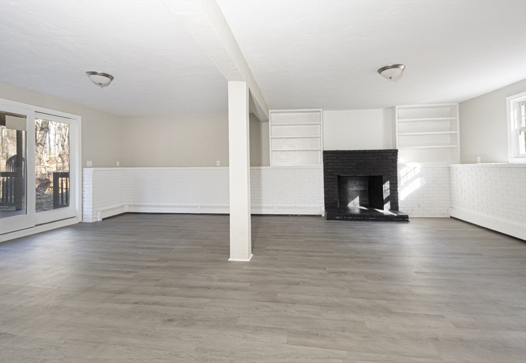 55 Dodge Road Sutton, MA 01590 - Photo 22 of 35 a view of empty room with wooden floor and fireplace