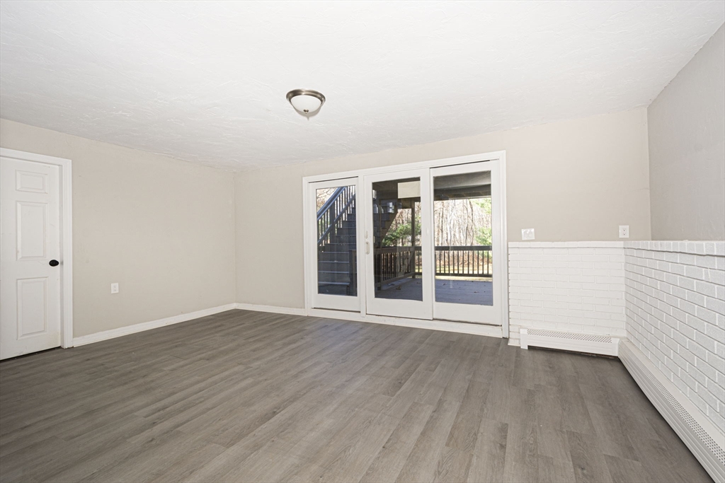 55 Dodge Road Sutton, MA 01590 - Photo 23 of 35 an empty room with wooden floor and windows