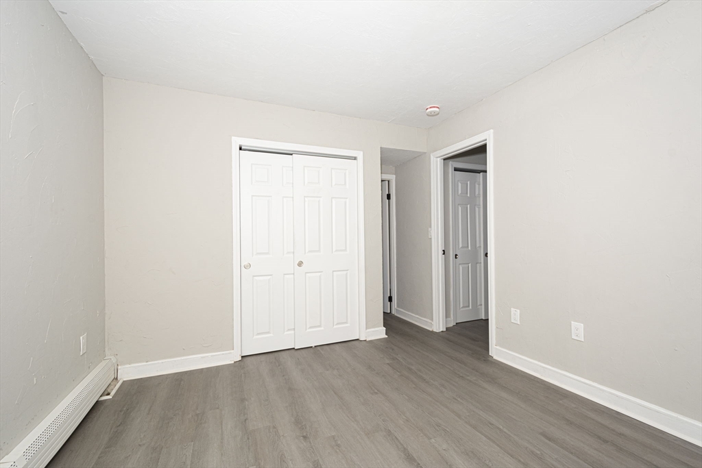55 Dodge Road Sutton, MA 01590 - Photo 27 of 35 an empty room with wooden floor and closet