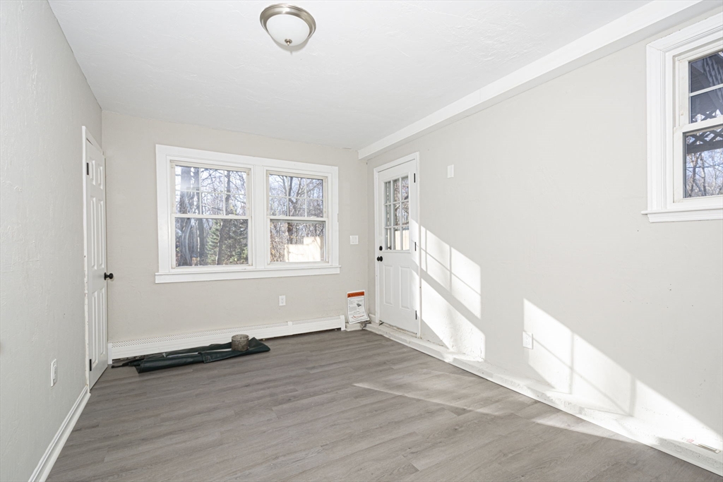 55 Dodge Road Sutton, MA 01590 - Photo 28 of 35 an empty room with wooden floor and windows