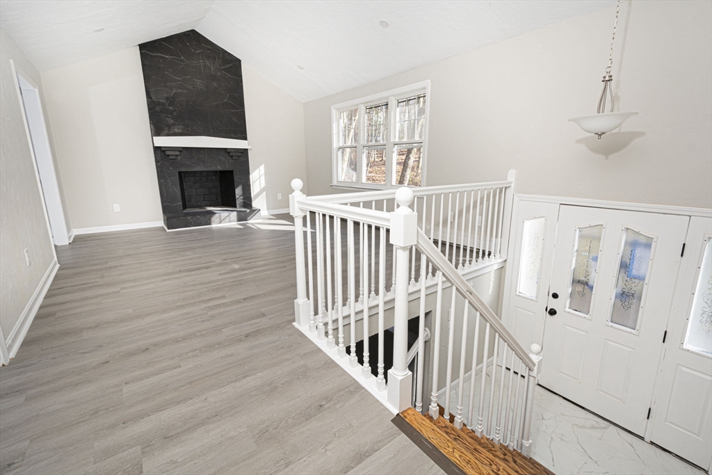 55 Dodge Road Sutton, MA 01590 - Photo 6 of 35 a view of a livingroom with wooden floor and a fireplace