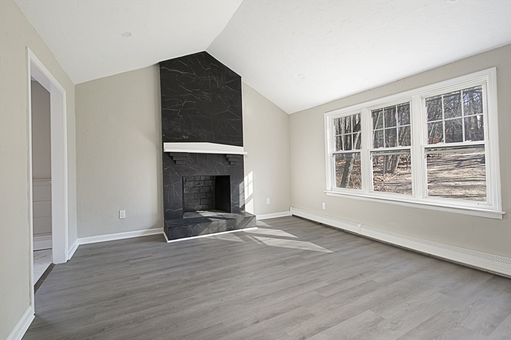 55 Dodge Road Sutton, MA 01590 - Photo 7 of 35 a view of an empty room with wooden floor fireplace and a window