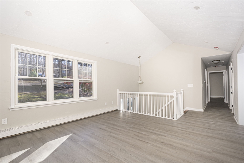 55 Dodge Road Sutton, MA 01590 - Photo 9 of 35 a view of an empty room with wooden floor and a window