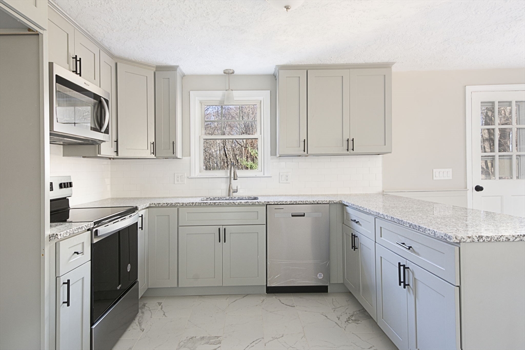 55 Dodge Road Sutton, MA 01590 - Photo 10 of 35 a kitchen with cabinets appliances a sink and a window