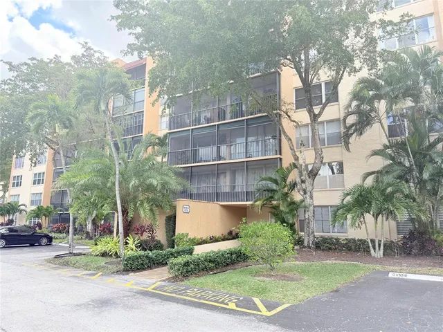 a view of a building with a yard