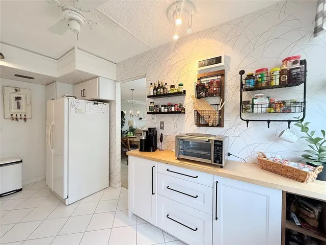 a kitchen with stainless steel appliances a refrigerator and cabinets