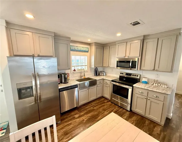 a kitchen with a stove a sink and a refrigerator